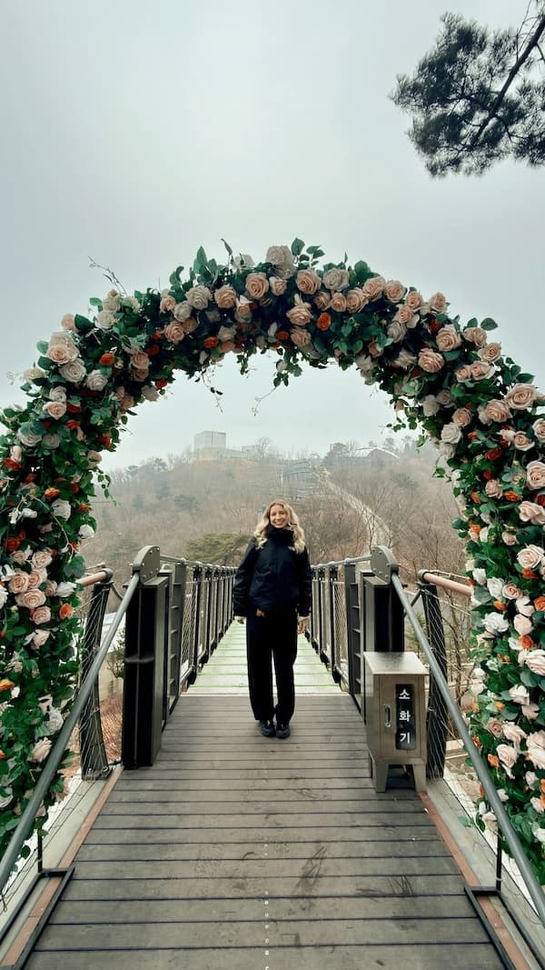 Tiah standing under a flower arch