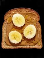 slice of toast with peanut butter, banana and honey